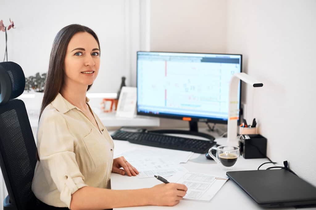 A woman sitting at her desk doing freelance work