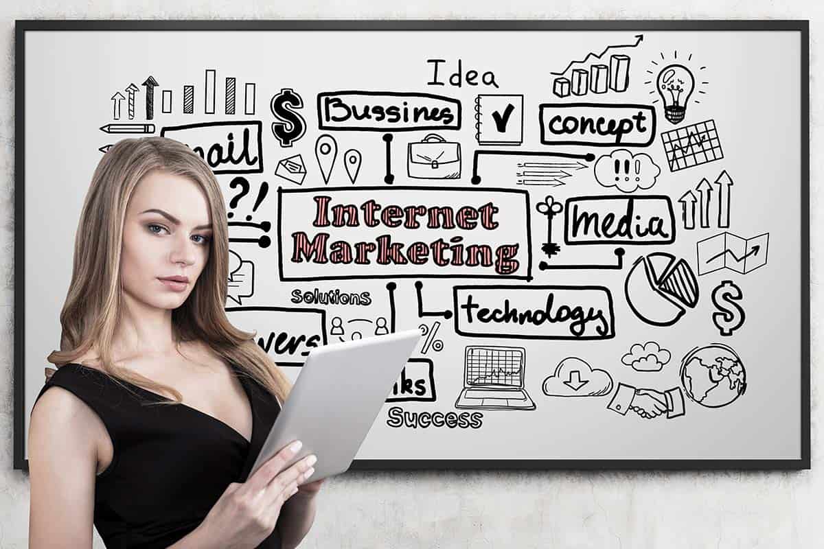 woman holding a tablet with a white board in the background explaining affiliate marketing